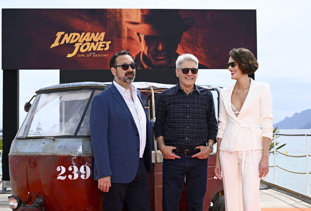 CANNES, FRANCE - MAY 18: (L-R) James Mangold, Harrison Ford, and Phoebe Waller-Bridge attend "Indiana Jones and The Dial Of Destiny" photocall at Carlton Pier on May 18, 2023 in Cannes, France. (Photo by Gareth Cattermole/Getty Images for Disney)