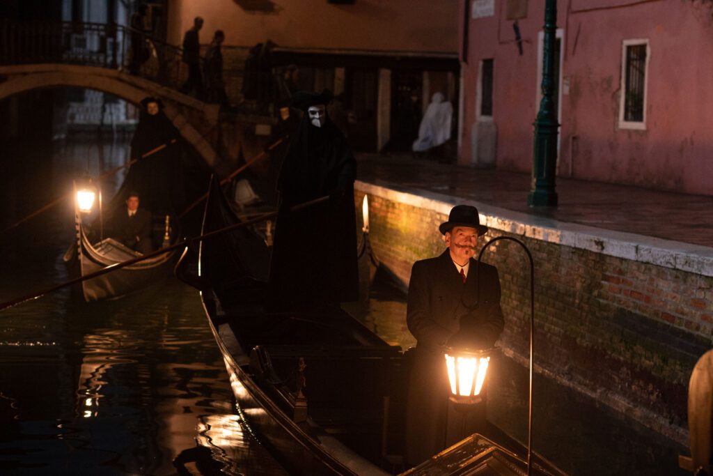 (L-R): Riccardo Scamarcio as Vitale Portfoglio and Kenneth Branagh as Hercule Poirot in 20th Century Studios' A HAUNTING IN VENICE. Photo by Rob Youngson. © 2023 20th Century Studios. All Rights Reserved.