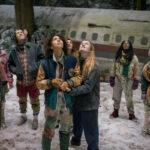 L-R: Sophie Thatcher as Teen Natalie, Jenna Burgess as Teen Melissa, Kevin Alves as Teen Travis, Courtney Eaton as Teen Lottie, Jasmin Savoy Brown as Teen Taissa, Sophie Nélisse as Teen Shauna, Liv Hewson as Teen Van, Nia Sondaya as Teen Akilah and Samantha Hanratty as Teen Misty in Yellowjackets, episode 8, season 4, streaming on Paramount+, 2026. Photo Credit: Eric Milner/Paramount+.